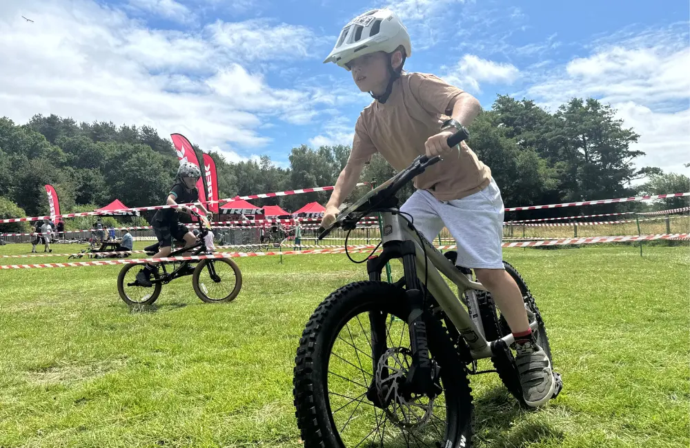 2 children cycling around a course