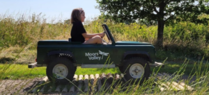 Girl driving a Moors Valley mini Land Rover 