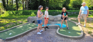Family playing adventure golf together